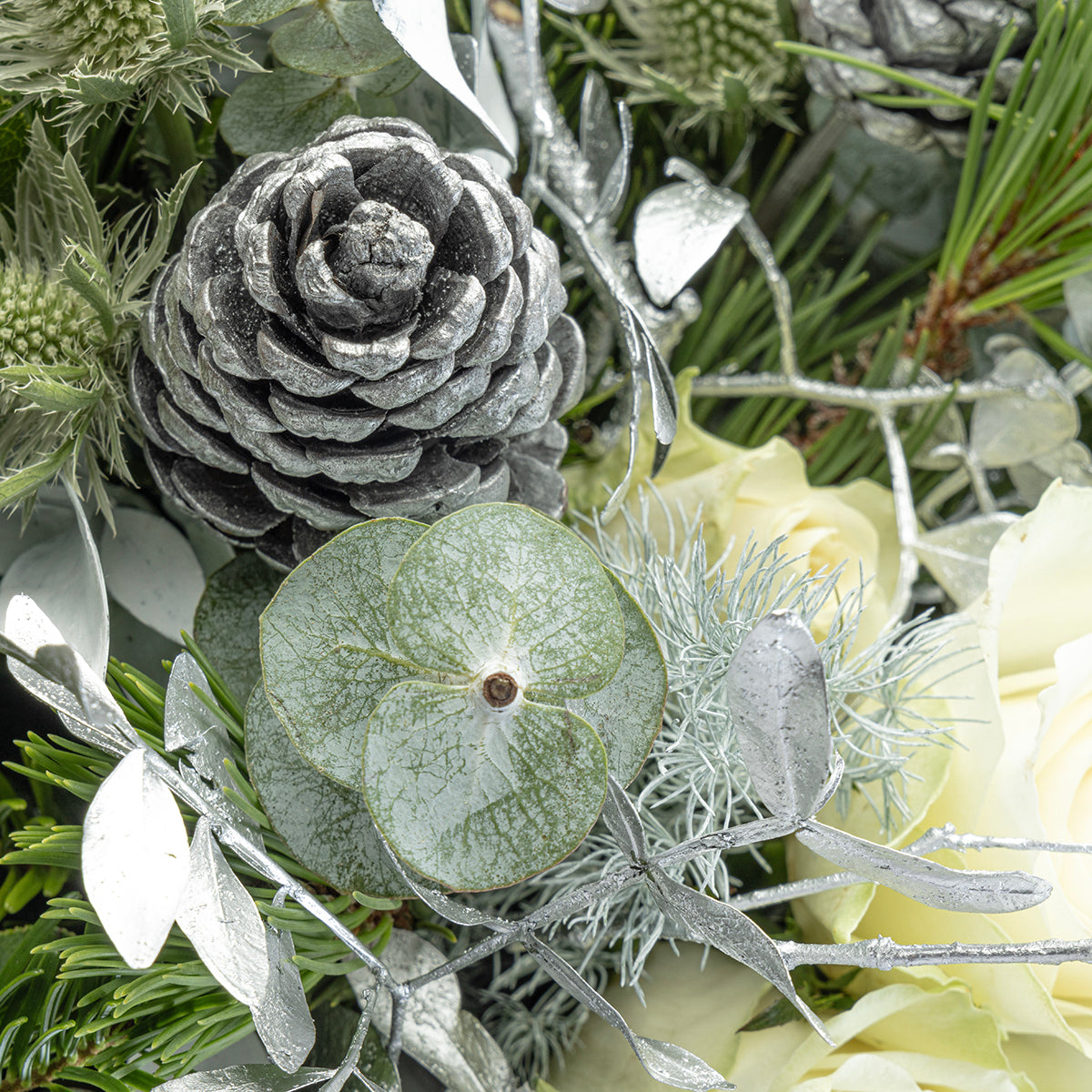 Close up view of pinecone from white Christmas tabletop arrangement