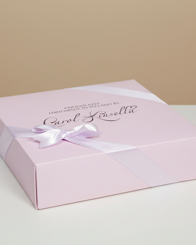 Pink gift box with a white ribbon on a beige background