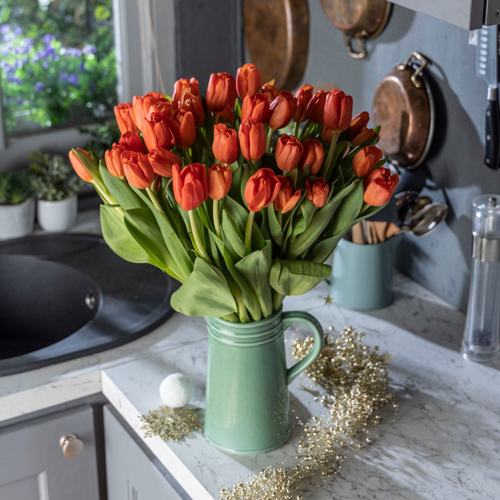 Lifestyle picture of Christmas orange tulips bouquet