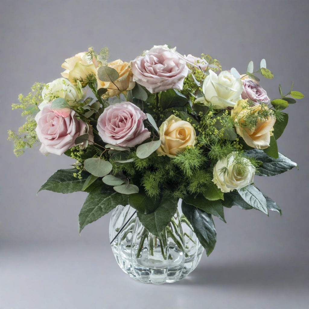 Pastels flower bouquet in glass vase