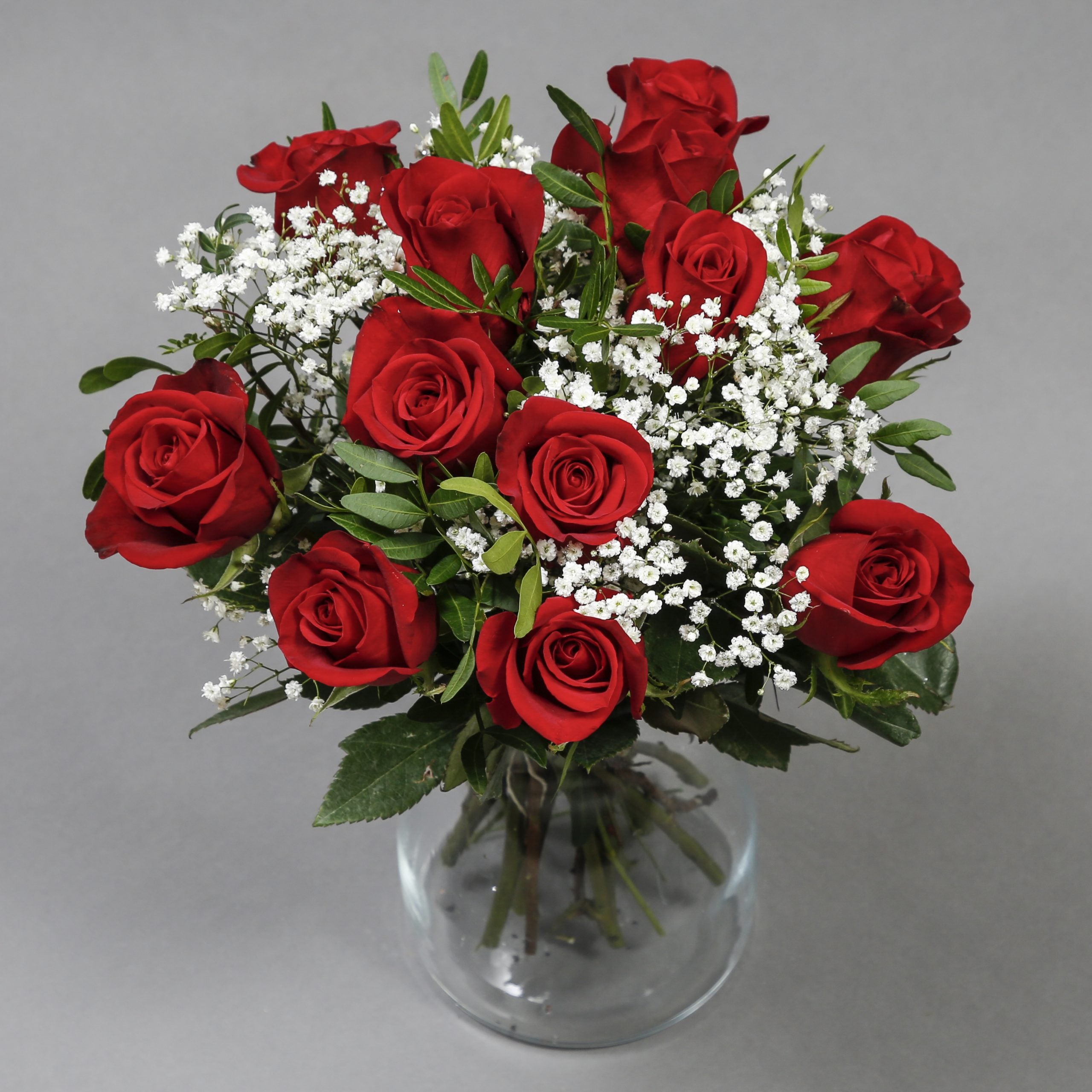 Dozen of red roses flower bouquet in glass vase
