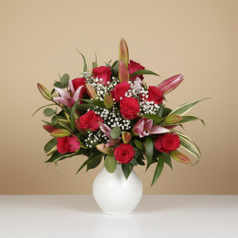 Rose and pink lily bouquet in a glass vase