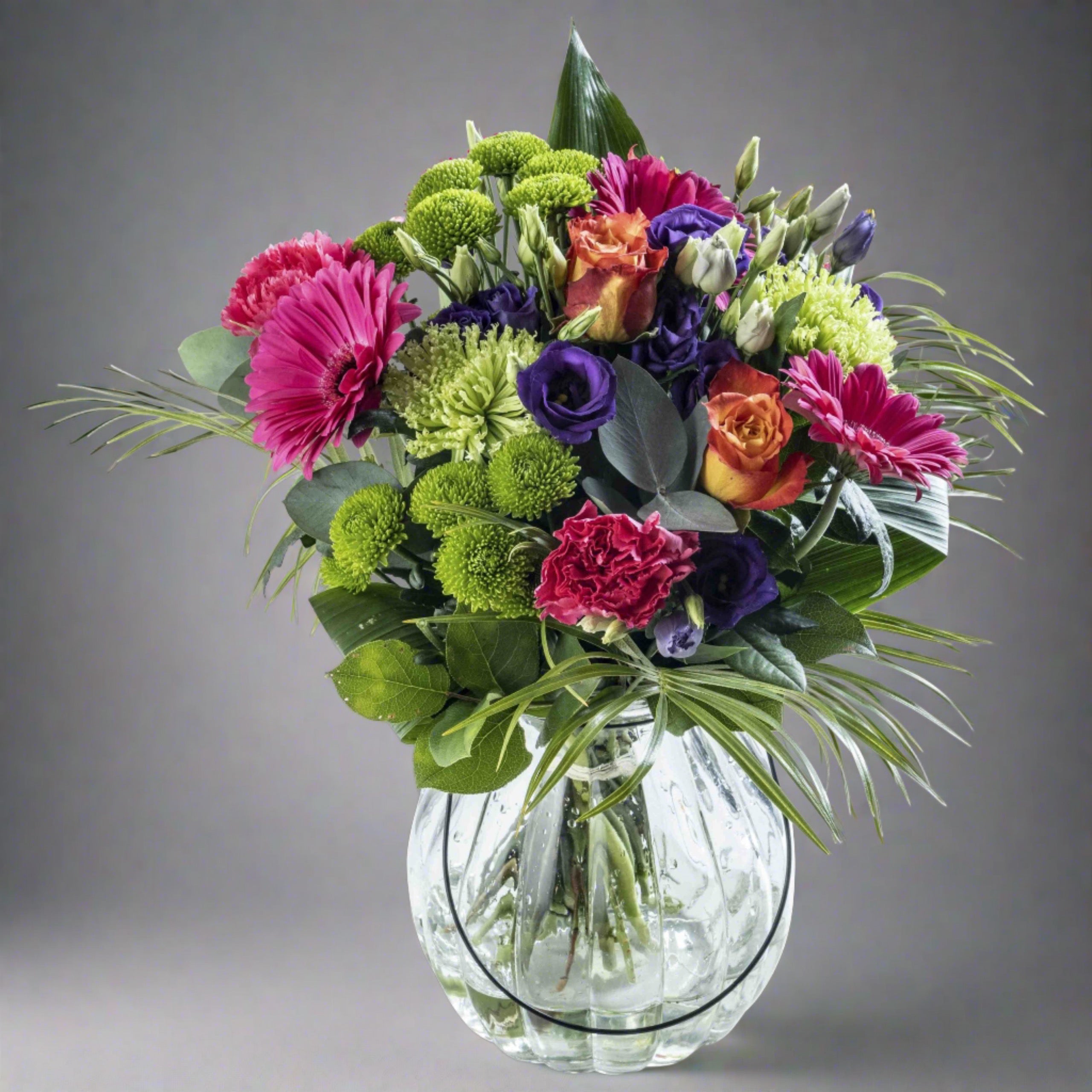 Rainbows flower bouquet in a glass vase