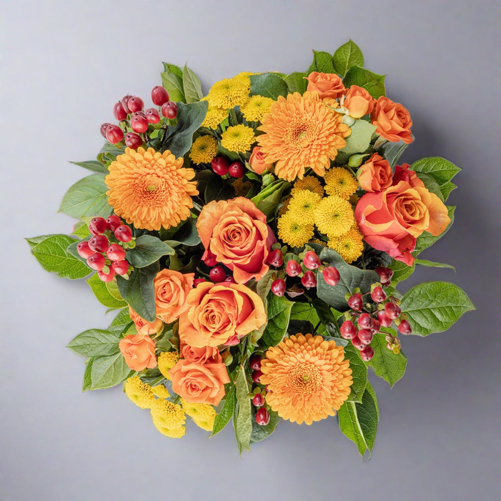 Top down view of Citrus bouquet and red wine bottle
