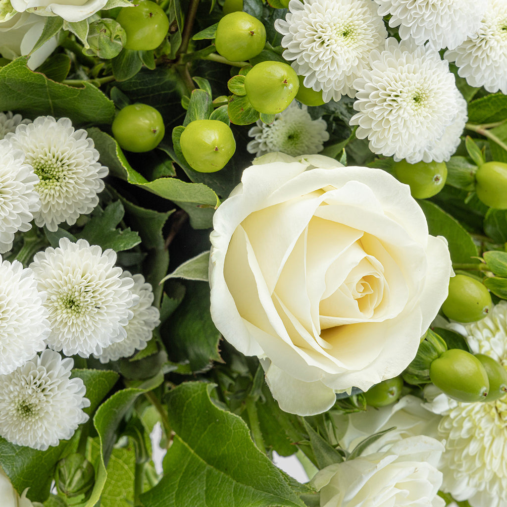Close up view of a white rose from White flowers bouquet