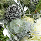 Close up view of pinecone from white Christmas tabletop arrangement