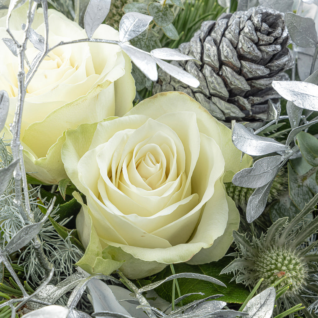 Close up of white rose from white Christmas tabletop arrangement