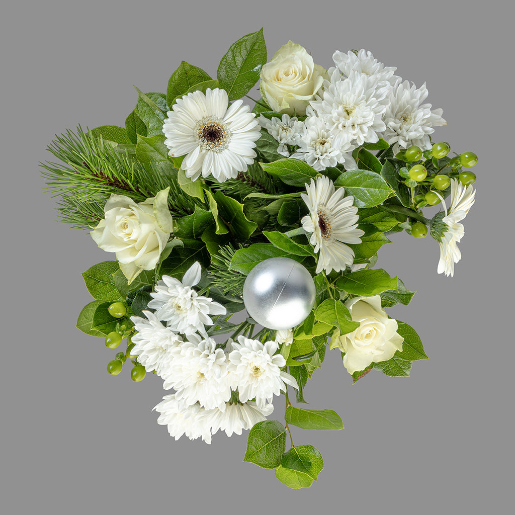 Top down view of Christmas white roses bouquet with white wine bottle