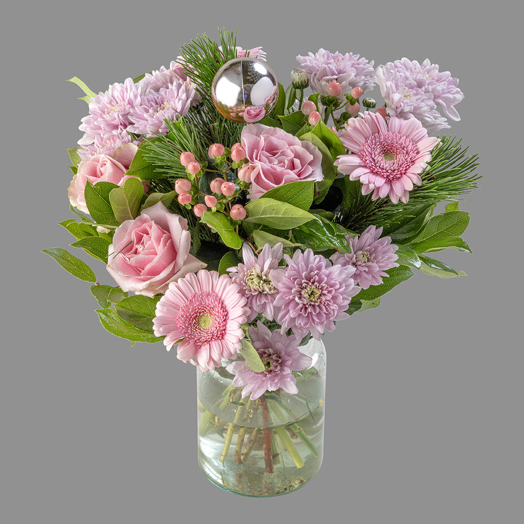 Christmas pink roses bouquet in a glass vase