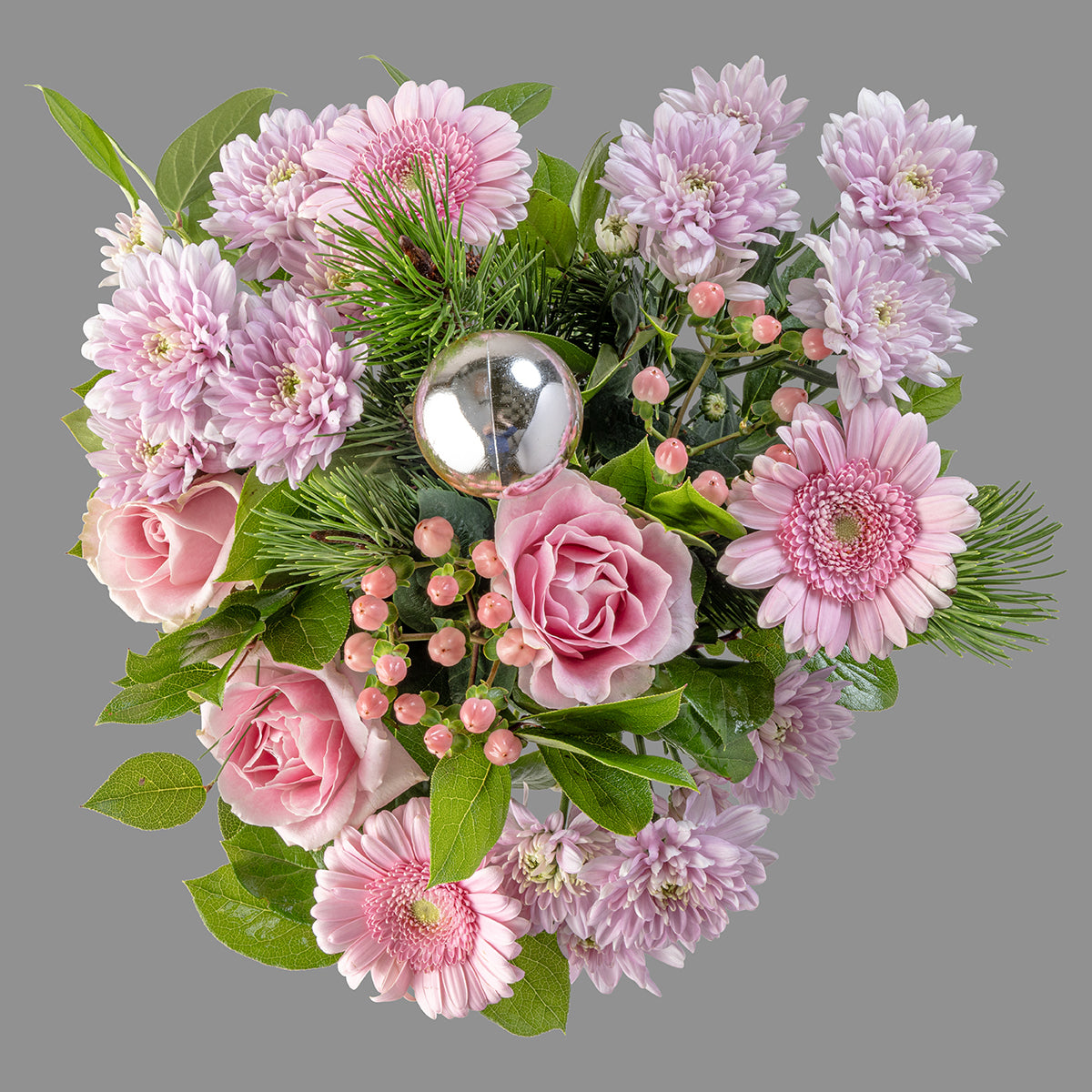 Top down view of Christmas pink roses bouquet in a glass vase
