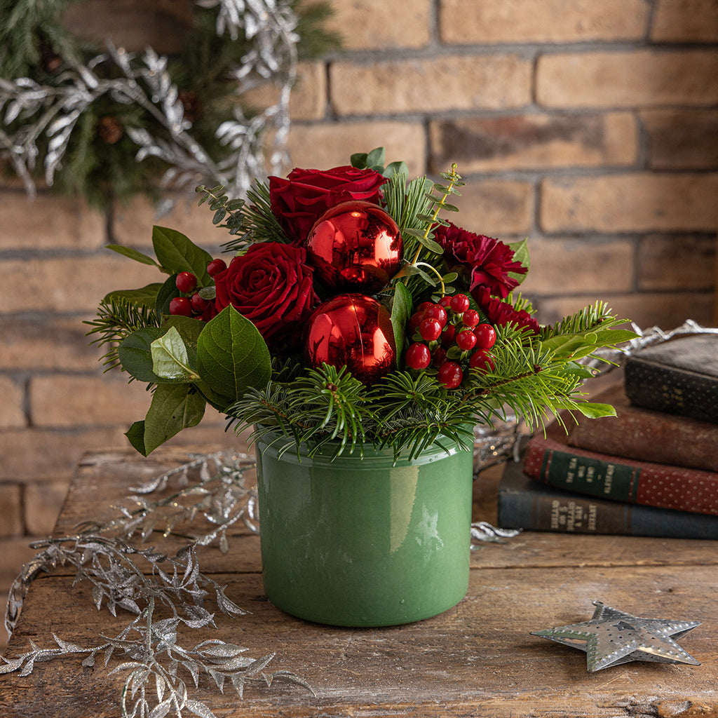 Lifestyle picture of Christmas reds tabletop bouquet