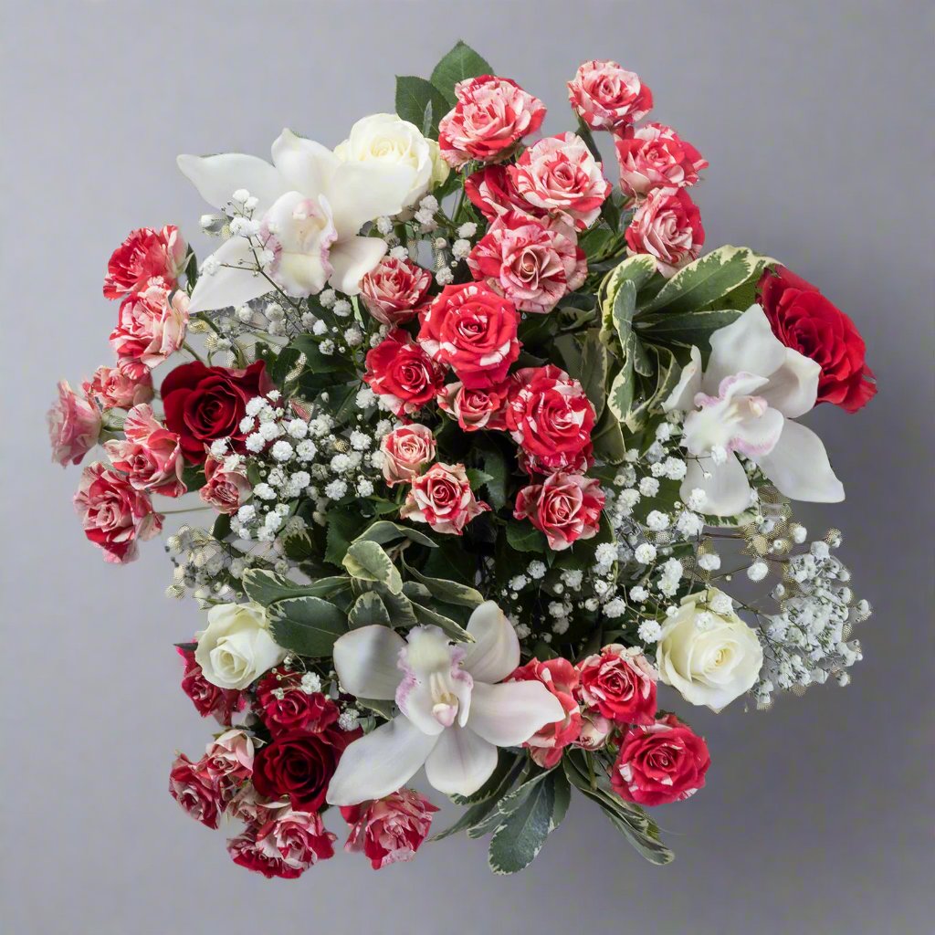 Top down view of Christmas Sparkle flower bouquet with speckled red and white roses