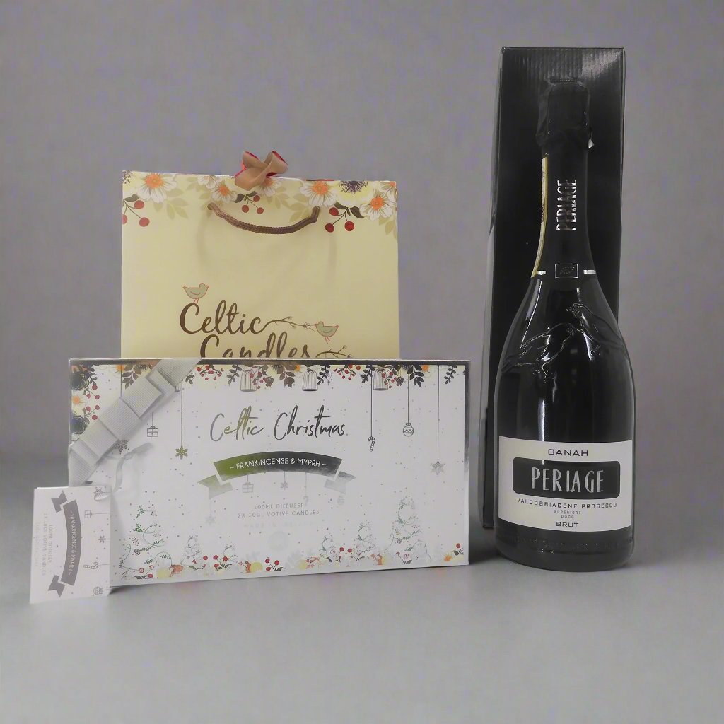 Luxury gift set with Periage prosecco, Celtic Christmas candles, and a diffuser from a low angle