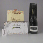 Luxury gift set with Periage prosecco, Celtic Christmas candles, and a diffuser from a low angle