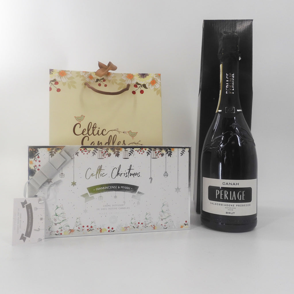 Luxury gift set with Periage prosecco, Celtic Christmas candles, and a diffuser from a low angle