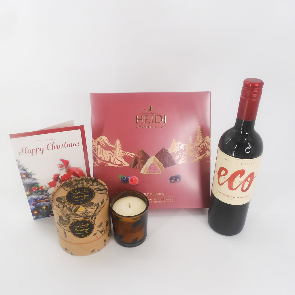 A luxurious Christmas gift set complete with a bottle of Eco red wine, Heidi Swiss Chocolate selection, a lovely scented candle and friendly Happy Christmas card