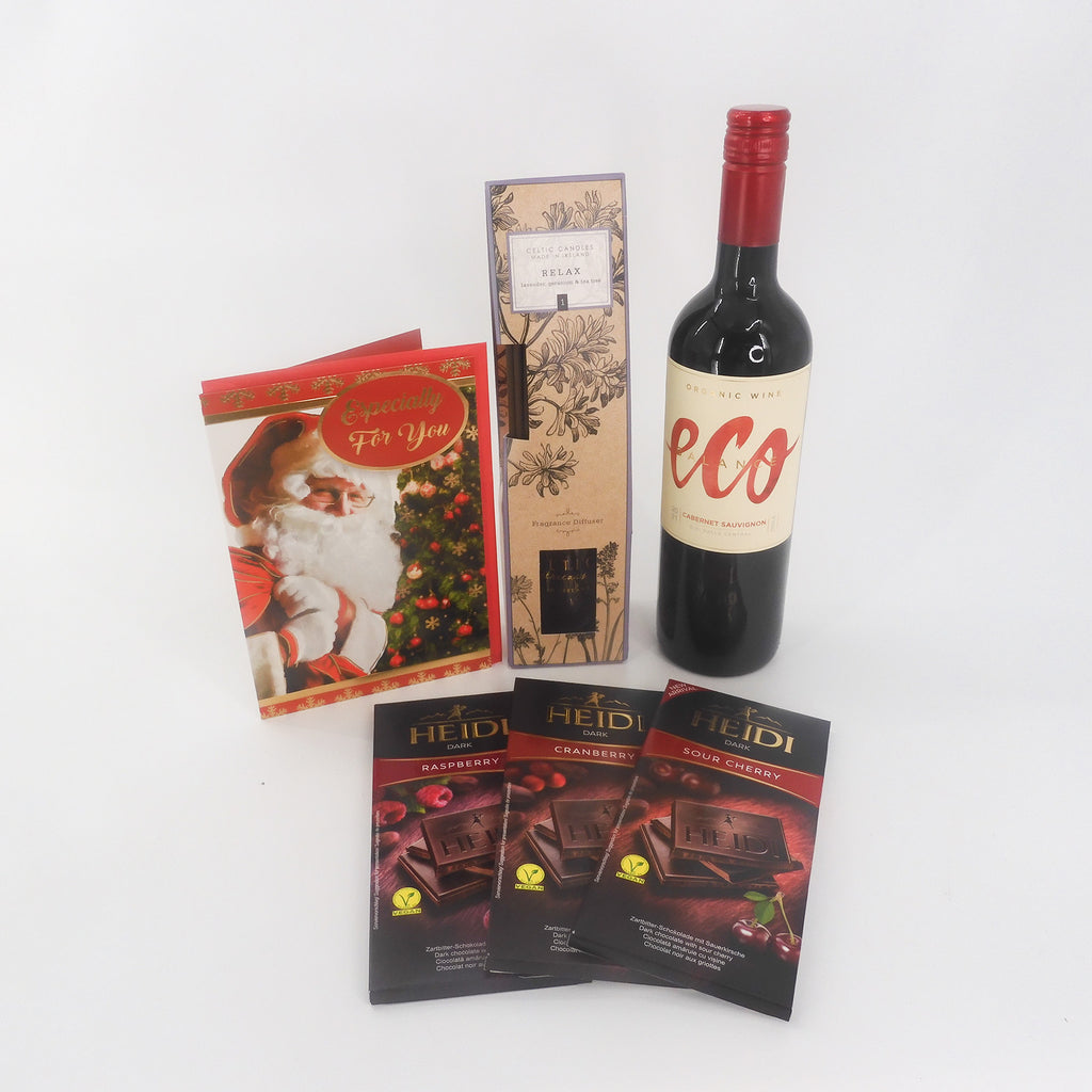 A luxury Christmas gift set complete with a bottle of red Eco wine, a Celtic Candles diffuser, three Heidi chocolates and a lovely Christmas card