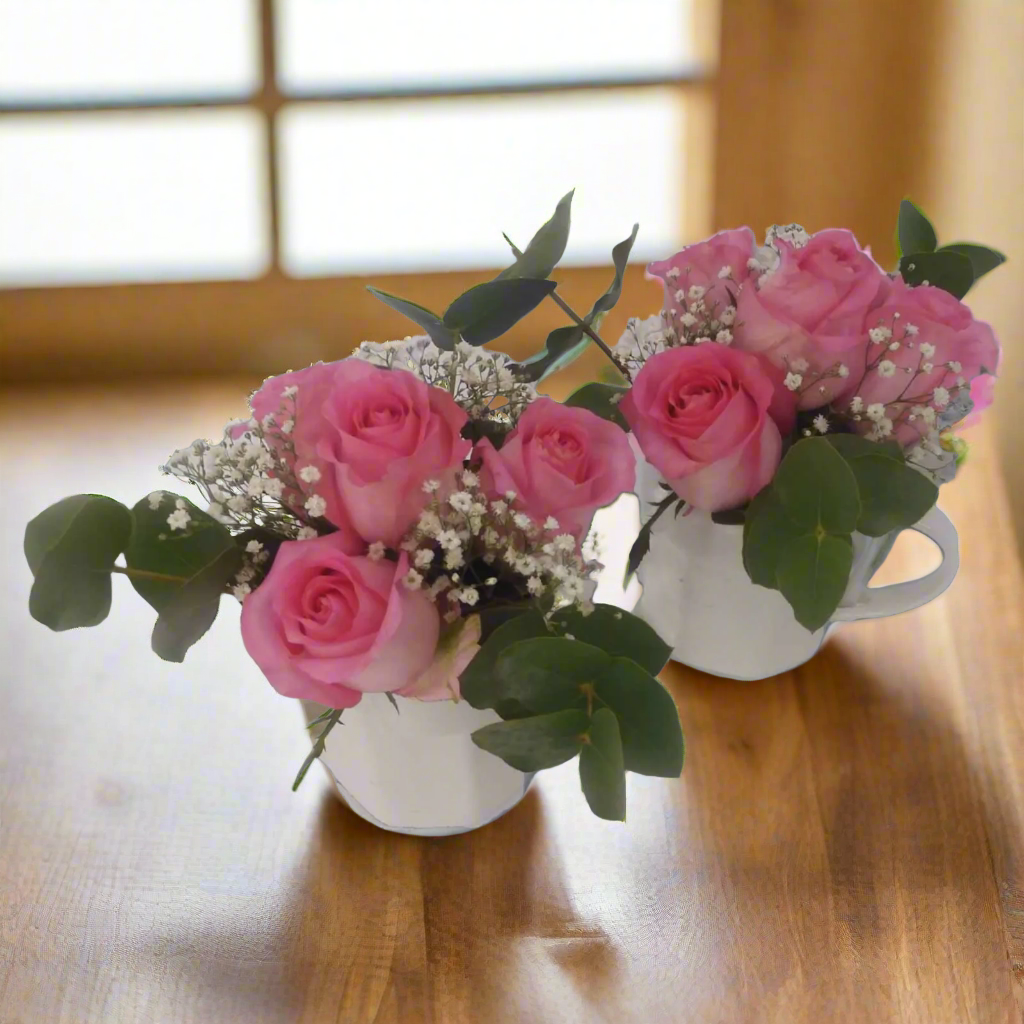 pink roses in white cups