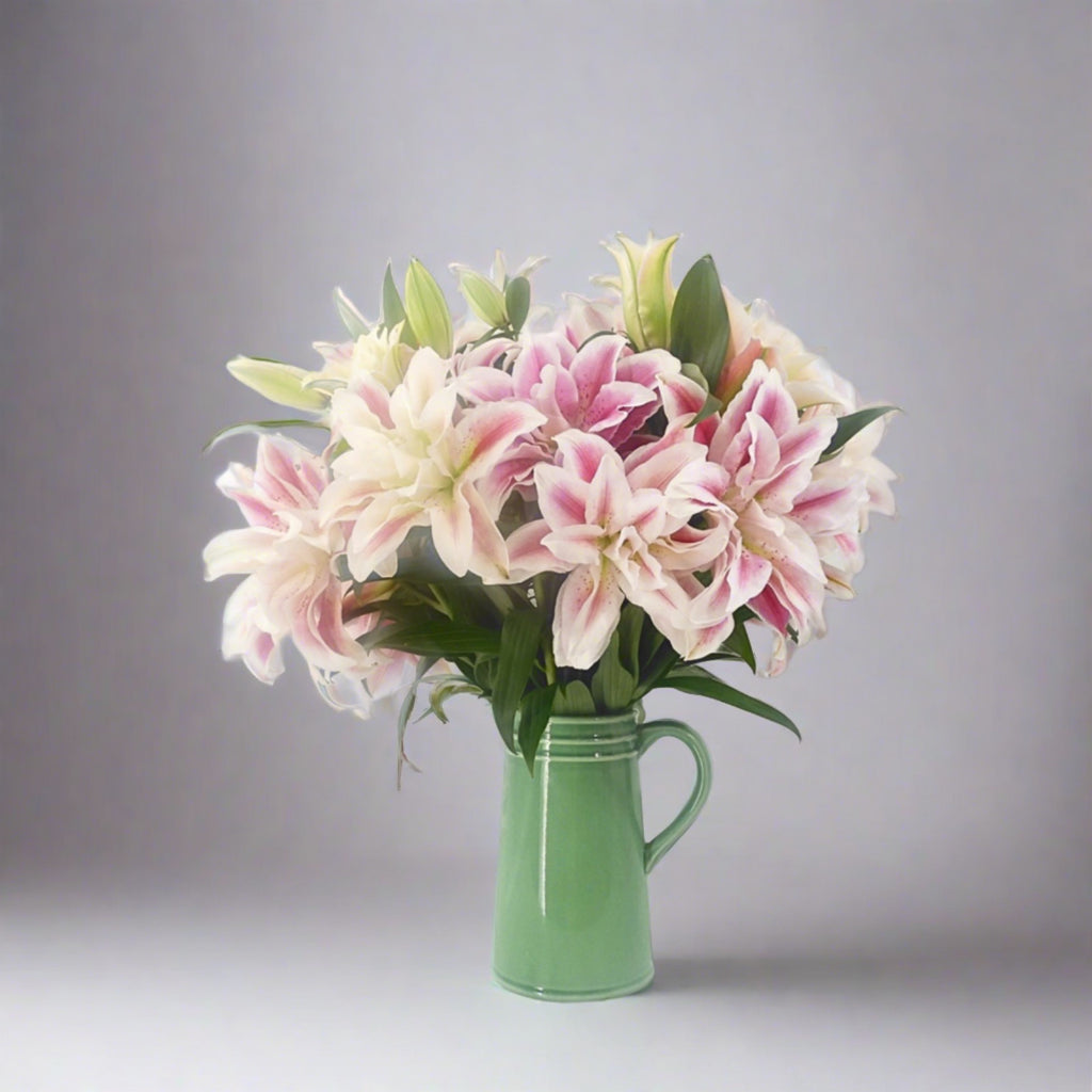 roselily bouquet in green ceramic jug