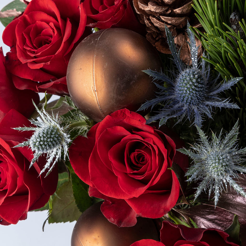 CLose up view of a red rose and bauble from Christmas velvet red roses bouquet