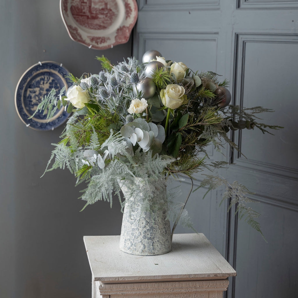 Lifestyle picture of White roses christmas frosty flower bouquet with baubles