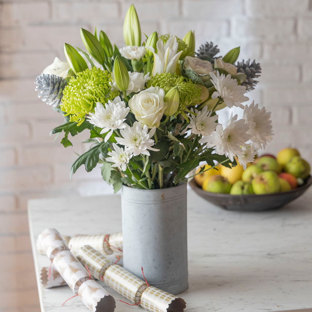 Lifestyle picture of Christmas Snowdrift bouquet with white roses