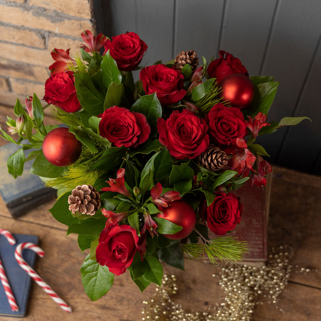 Lifestyle picture of Red roses christmas bliss flower bouquet with baubles