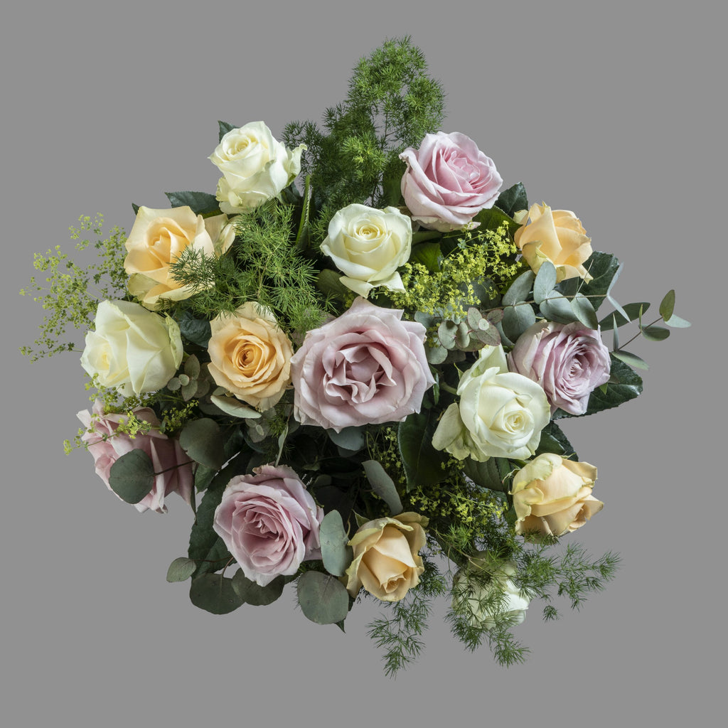 Top down view of Pastels flower bouquet in glass vase