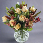 Peachy flower bouquet in a glass vase