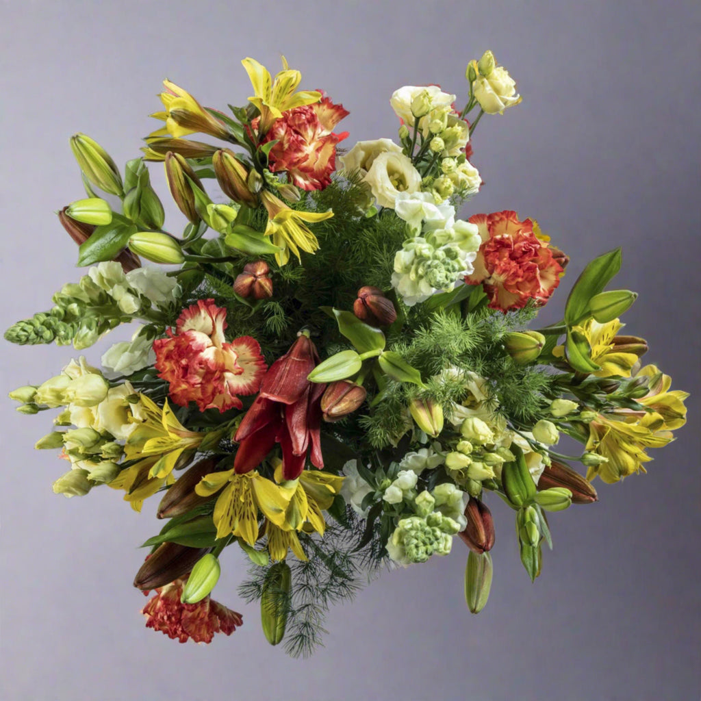 Top down view of sunrise flower bouquet in a glass vase