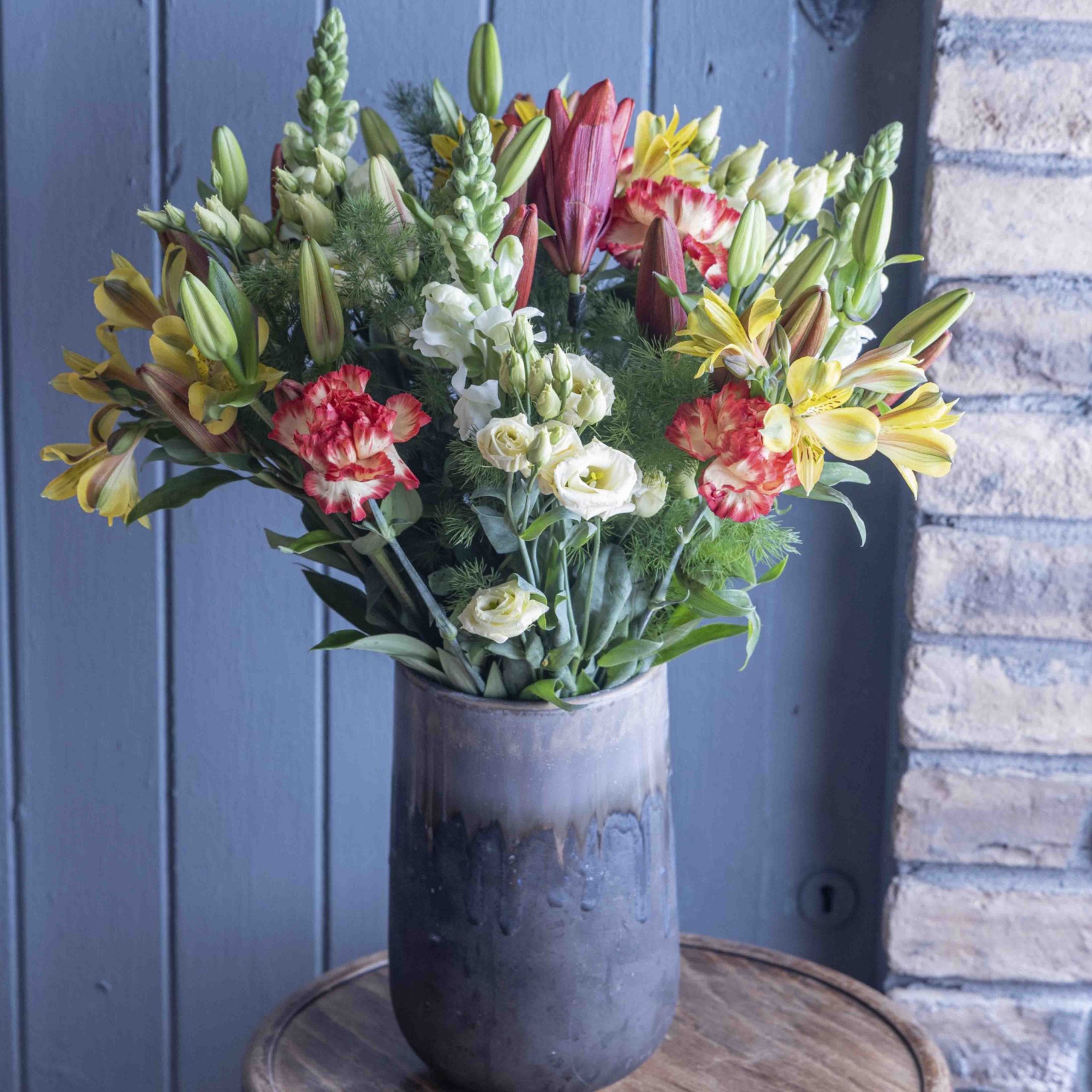 Lifestyle picture of sunrise flower bouquet in a glass vase