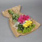 Green, yellow and pink flowers in paper wrapping