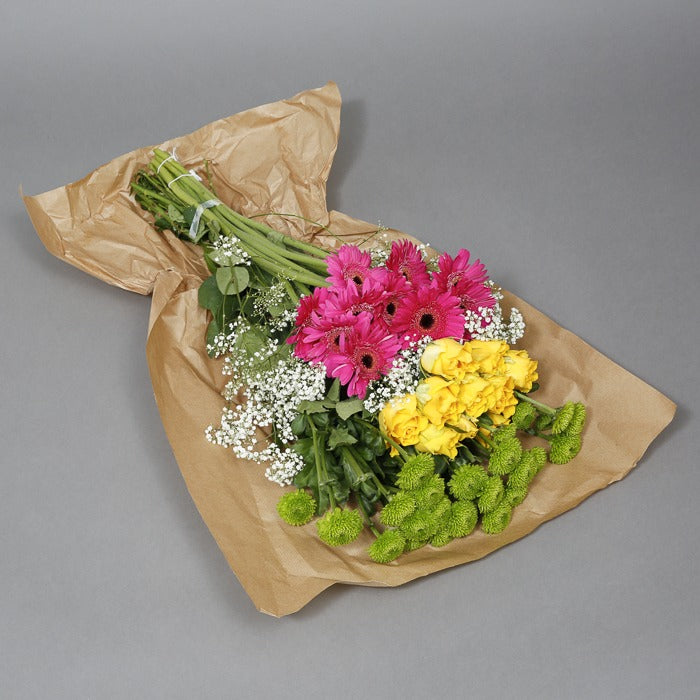 Green, yellow and pink flowers in paper wrapping