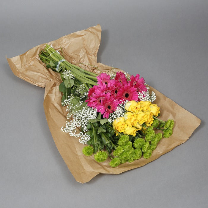 Green, yellow and pink flowers in paper wrapping