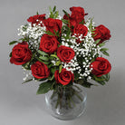 Dozen of red roses flower bouquet in glass vase