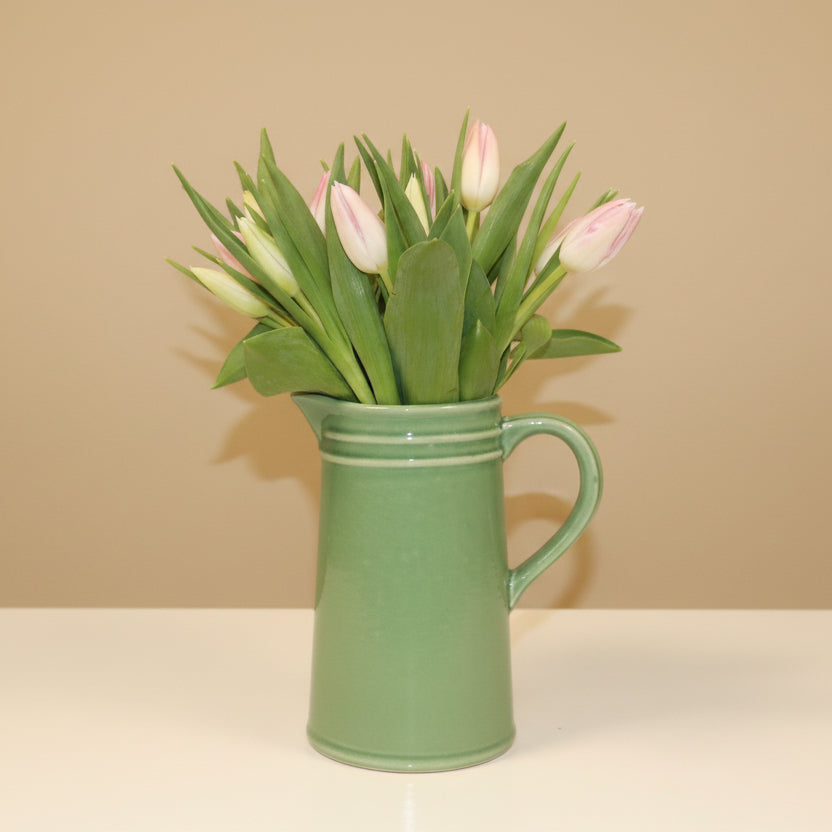 Mothers day tulips in green ceramic jug
