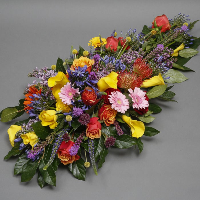 close view of a mixed flower funeral spray