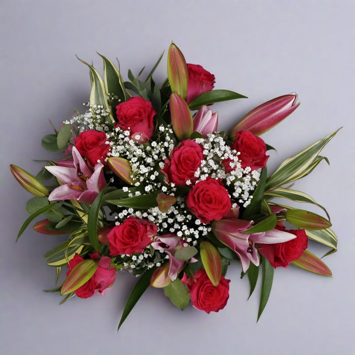 Top down view of Rose and pink lily bouquet