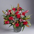 Rose and pink lily bouquet in a glass vase