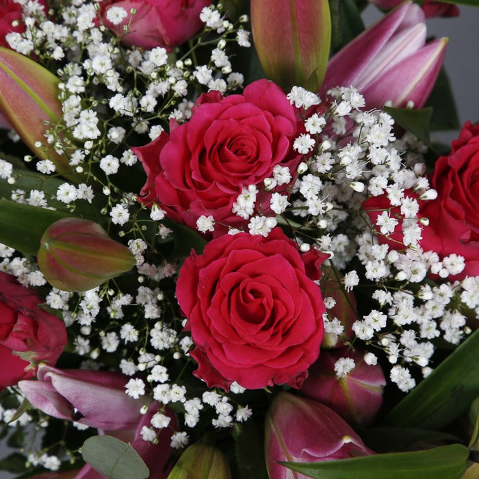 Close up of red roses from Rose and pink lily bouquet