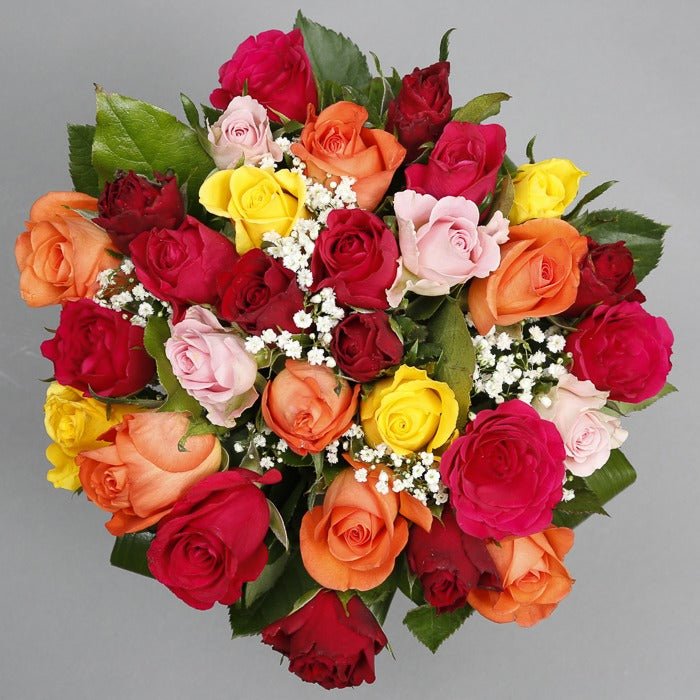 Top down view of Assorted roses bouquet in a glass vase