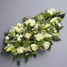 Angled view of White sympathy funeral spray