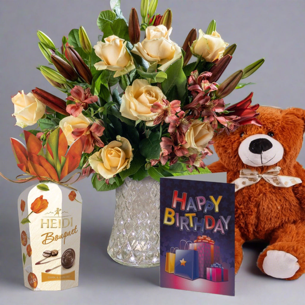Peachy flowers bouquet bundle with chocolates, a birthday card and a teddy bear