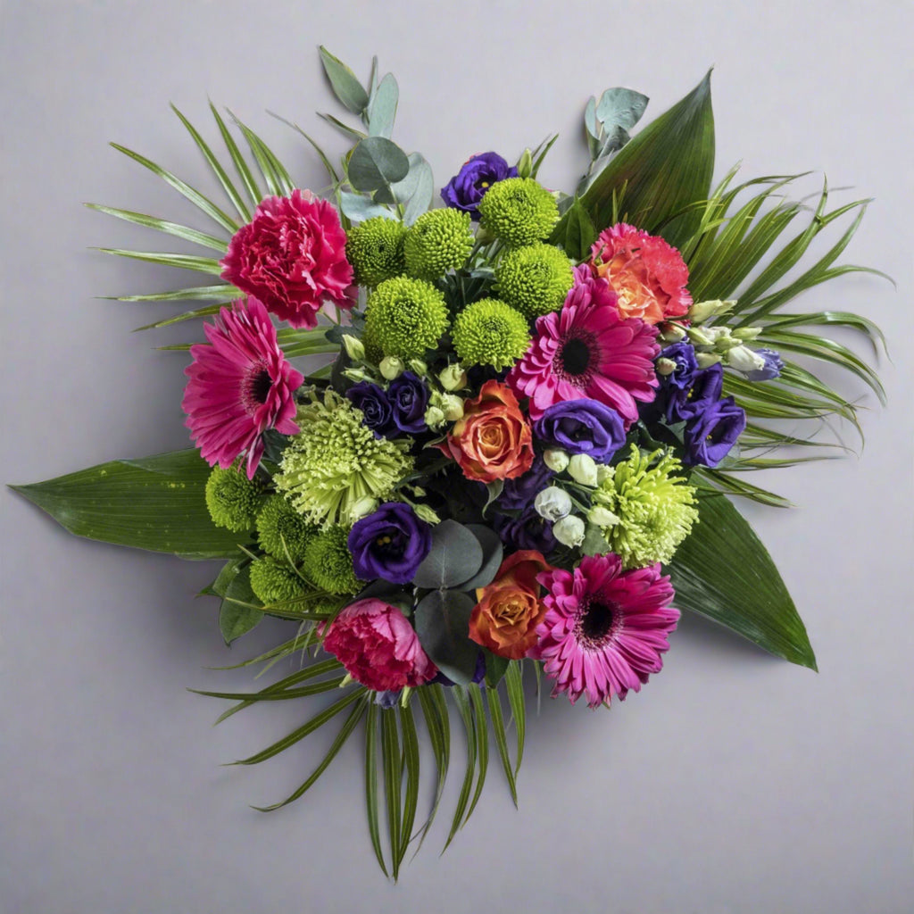 Top down view of Rainbows flower bouquet in a glass vase