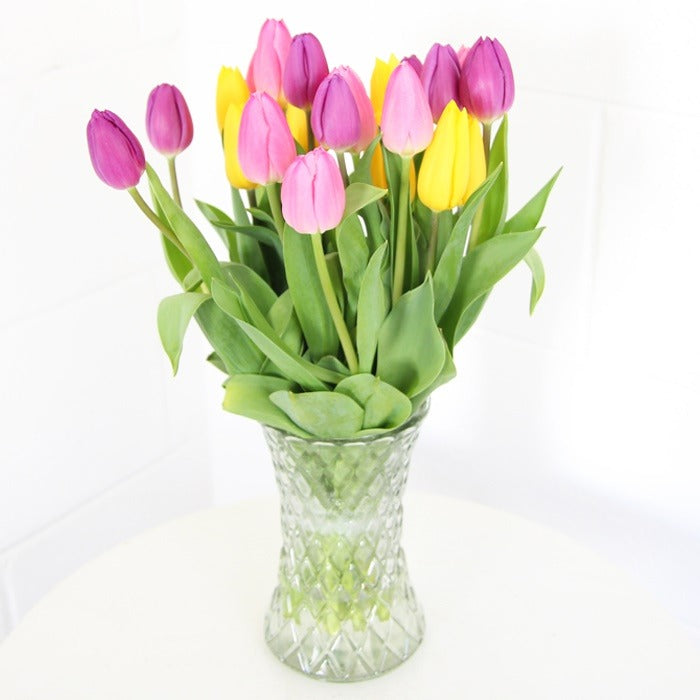 Easter yellow and pink Tulips in a cut glass vase